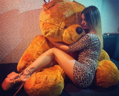 Hugging the teddy bear.