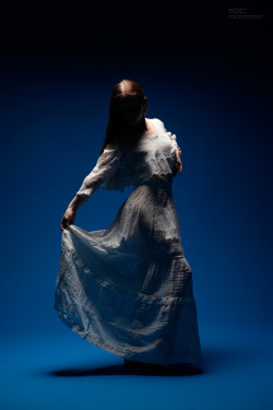 Silhouetted woman in white dress.