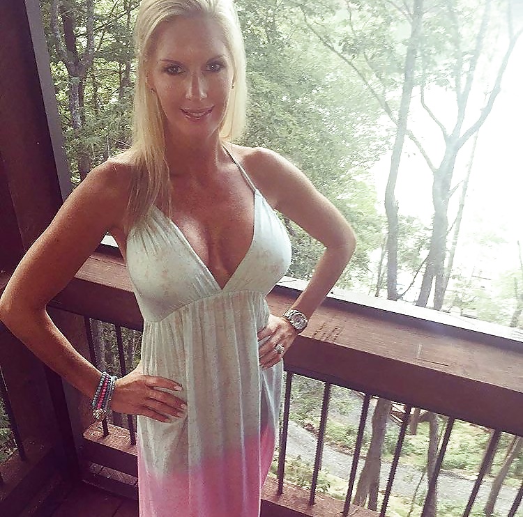 Blonde MILF with a thin dress and thick tits.