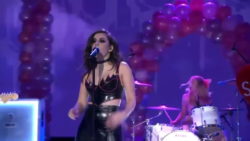 Charli XCX grabbing and shaking her plots on television concert