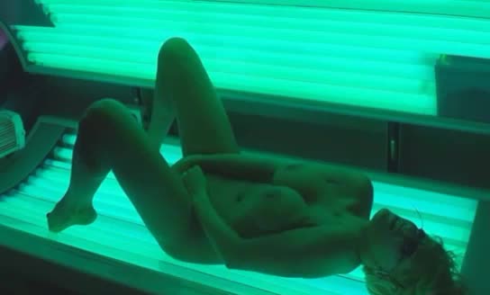 Busty blonde cumming while in the tanning bed